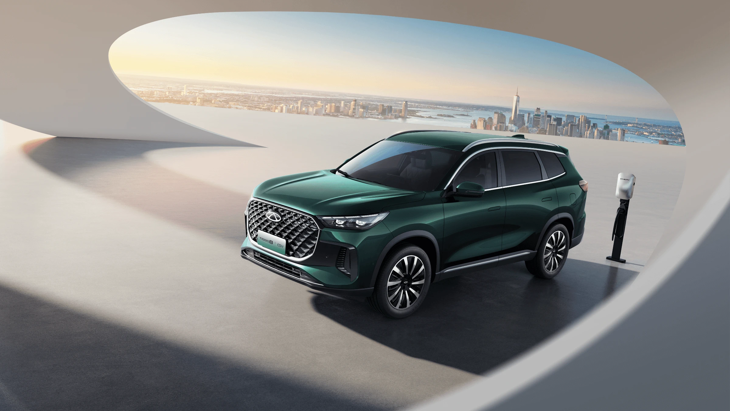 Chery Tiggo 8 PHEV — parked beside a home EV charging station with city skyline